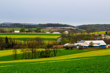 Fototapeta na wymiar Pennsylvania countryside and farms in spring near Kutztown. Fields just starting to be plowed.