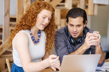 Two young people in office