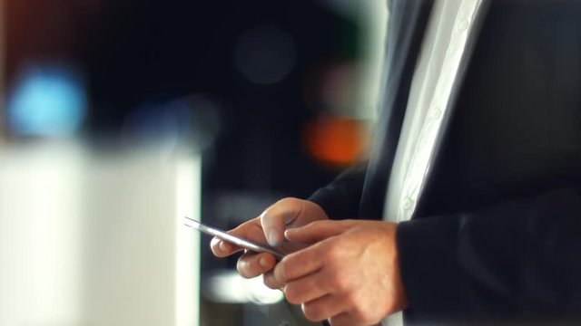 Using a Smartphone, sliding the screen and taping, close up shot with soft bokeh