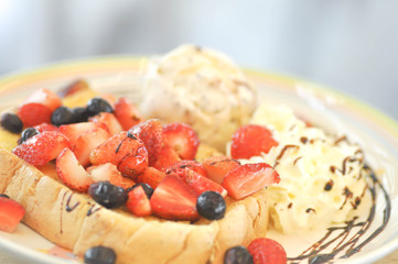 toast with strawberry  , blueberry , whipped cream  and ice cream