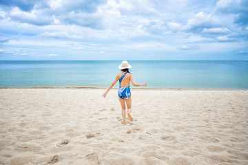 Fototapeta na wymiar Young happy woman running on the beach
