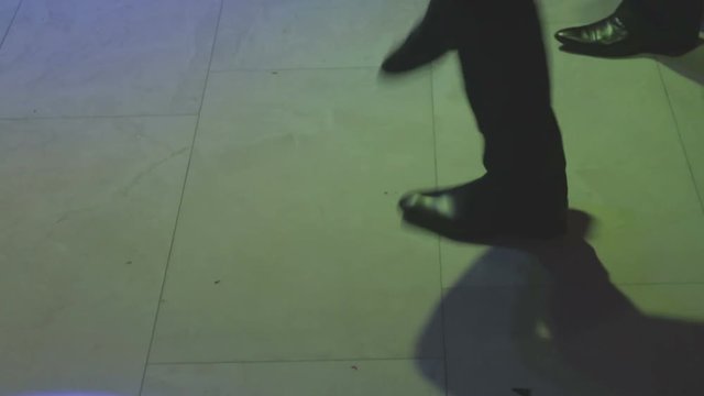 Legs of a dancing person in the light of soffits