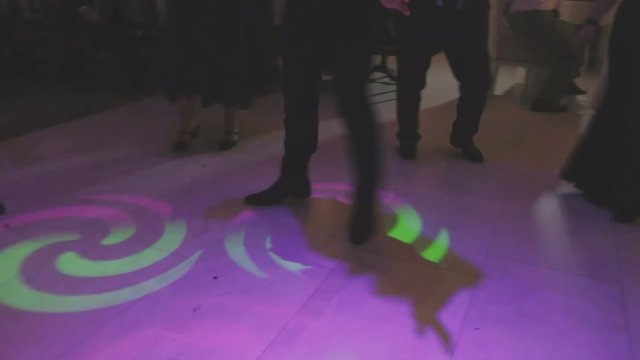 Legs of a dancing person in the light of soffits