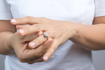 Woman put on her wedding ring