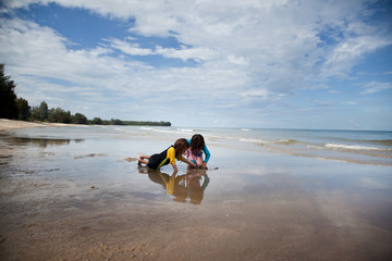 Little girls playing on the beach, family beach vacation