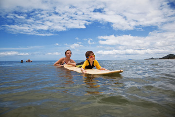 Obraz premium Family on vacation. Family Surfing. Summer holidays.