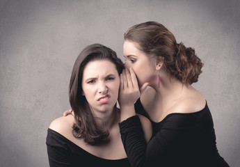 girl telling secret things to her girlfriend