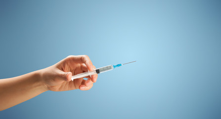 Female doctor holding syringe