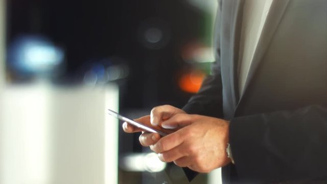 Using a Smartphone, sliding the screen and taping, close up shot with soft bokeh
