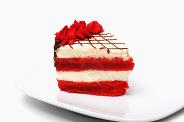 A piece of cherry cake on a plate on a white background