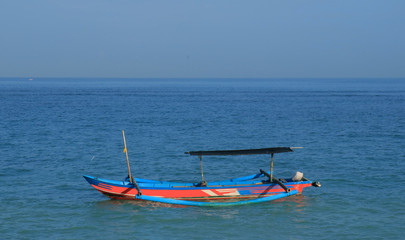 Traditional fishing boat or jukung at Kuta beach, Bali, Indonesia.