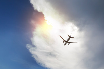 Airplane in the blue sky, cloud and sunlight