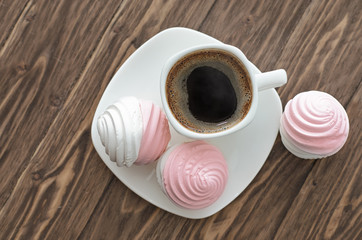 Fototapeta na wymiar Sweet pink marshmallow - zephyr and cup of coffee
