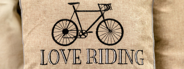 Black sport retro bike embroidered on gold cushion with love riding writing