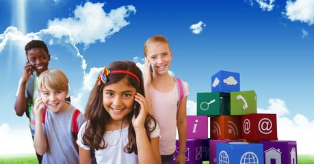 Obraz premium Happy kids using smart phones with apps icons in background