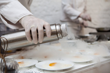 Obraz na płótnie Canvas Chef is cooking ice cream with liquid nitrogen