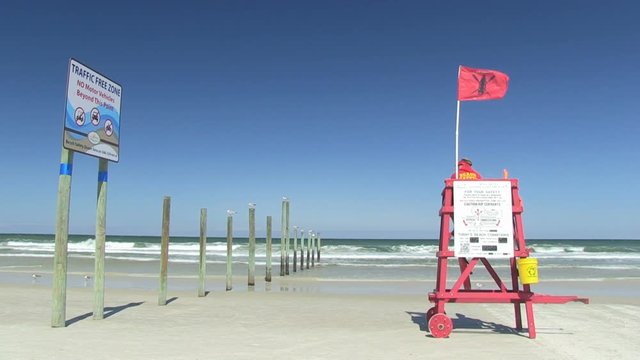 Daytona Beach, Atlantic coast, Florida. Daytona Beach pier and a manned lifeguard tower with the red flag - 7