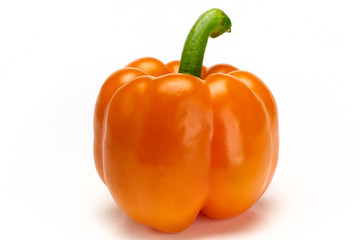 Close up of organic orange bell pepper on white