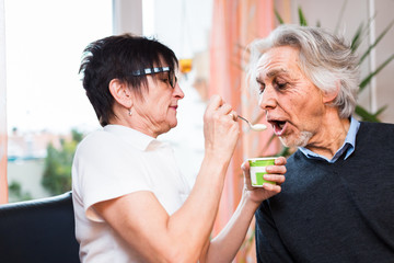 Nurse Feeding Senior Man