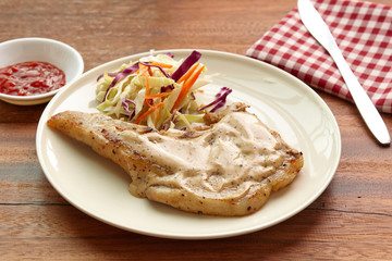 Pork chops steak hot grilled with salad, lunch  or dinner favorite dish.