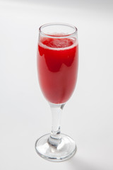Red wine in a glass on white background