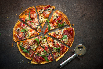 Traditional italian pizza. Top view at dark stone table.