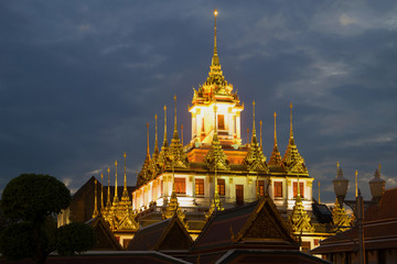 Naklejka premium A view of the top of Chedi Loha Prasat (Metal Palace) of the Buddhist temple of Wat Ratchanadda in the evening twilight. Bangkok, Thailand