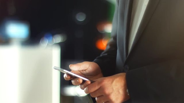 Using a Smartphone, sliding the screen and taping, close up shot with soft bokeh