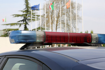police car with European and Italian flags on background outdoor