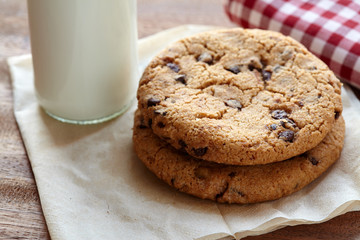Chocolate chips cookies with milk bottle in background on the wooden table. quick and eays meal in the morning. Close up shot.