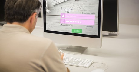 Rear view of businessman logging in on site using computer
