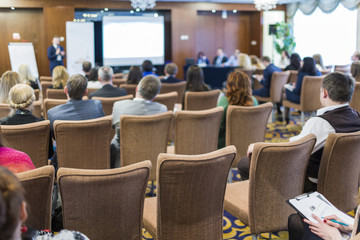 Business Conferences Concepts. People at the Law Conference Listening to The Host in Front of The Big Screen.