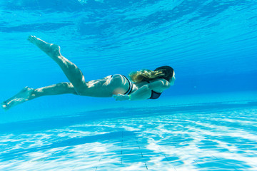 girl dive under blue water snorkeling in pool, Summer vocation