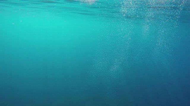 Underwater GoPro shots, sun rays through the water, splashes and bubles