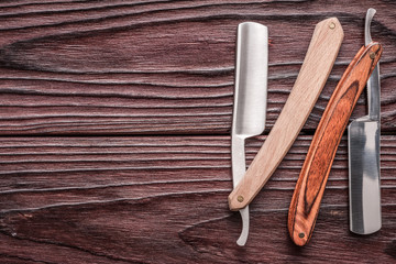 Vintage barber shop straight razor tool on wooden background