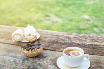 cup of tea with lemon on wooden background