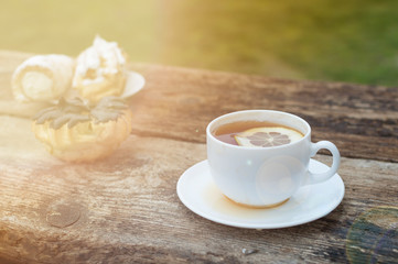 cup of tea with lemon on wooden background
