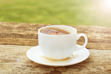 cup of tea with lemon on wooden background