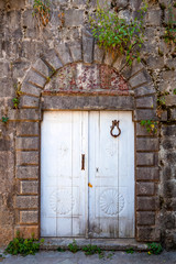 Old gate with door knob in the ancient town in Montenegro.