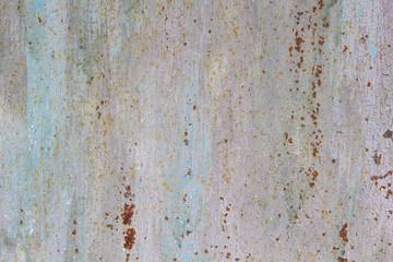 Rusted painted metal wall corrosion with streaks of rust