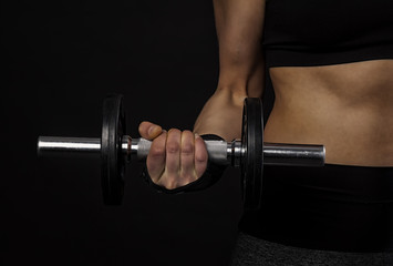 Female athlete exercising with a dumbbell