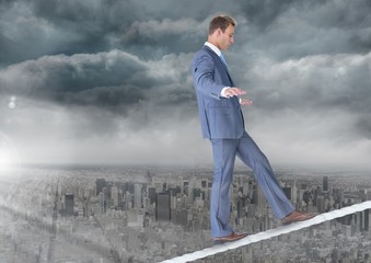 Walking businessman on tightrope over city and clouds