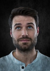 Man looking up against black wall
