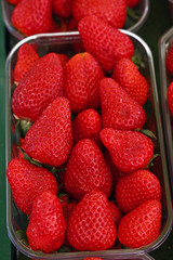 Fresh red ripe strawberries in plastic container