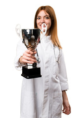 Young doctor woman holding a trophy