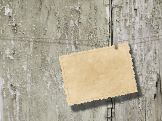 Blank old postcard frame against weathered wooden background © ma3d.it