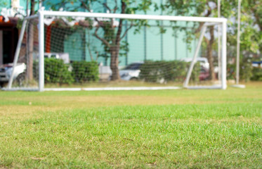  Football field  with  blurred a white goal in the background.