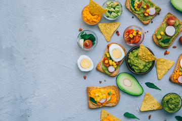 Sandwiches with guacamole, avocado, arugula and fresh ingredients . Low carbohydrate diet of organic products. Flat lay with copy space. Healthy breakfast concept.