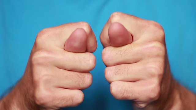 Man's thumbs in fico closeup