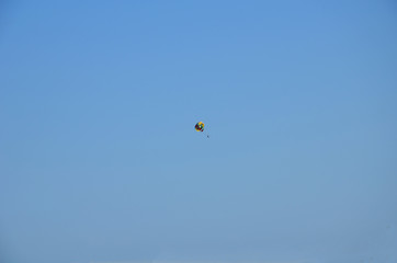 Paraglide silhouette in a light of sunrise above the misty carpathian valley.
